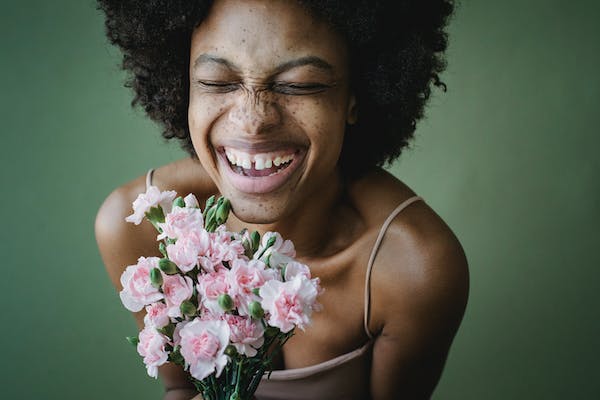 Black woman holding a flower